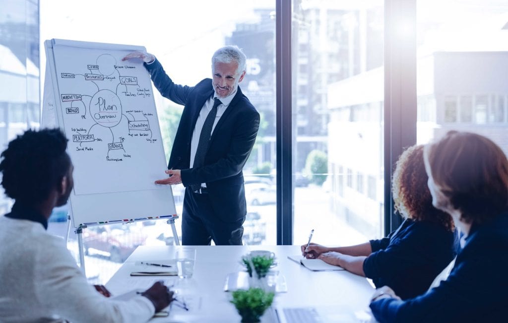 Businessman giving a presentation on a whiteboard